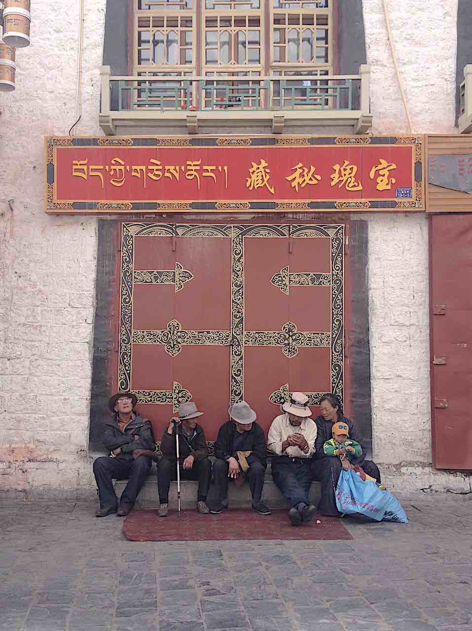 Tibetan family resting along the Barkhor Circuit, Lhasa